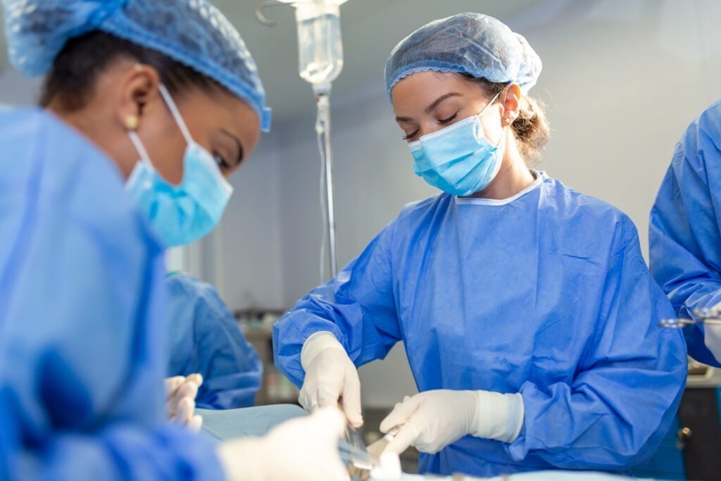 Team of professional doctors performing operation in surgery room